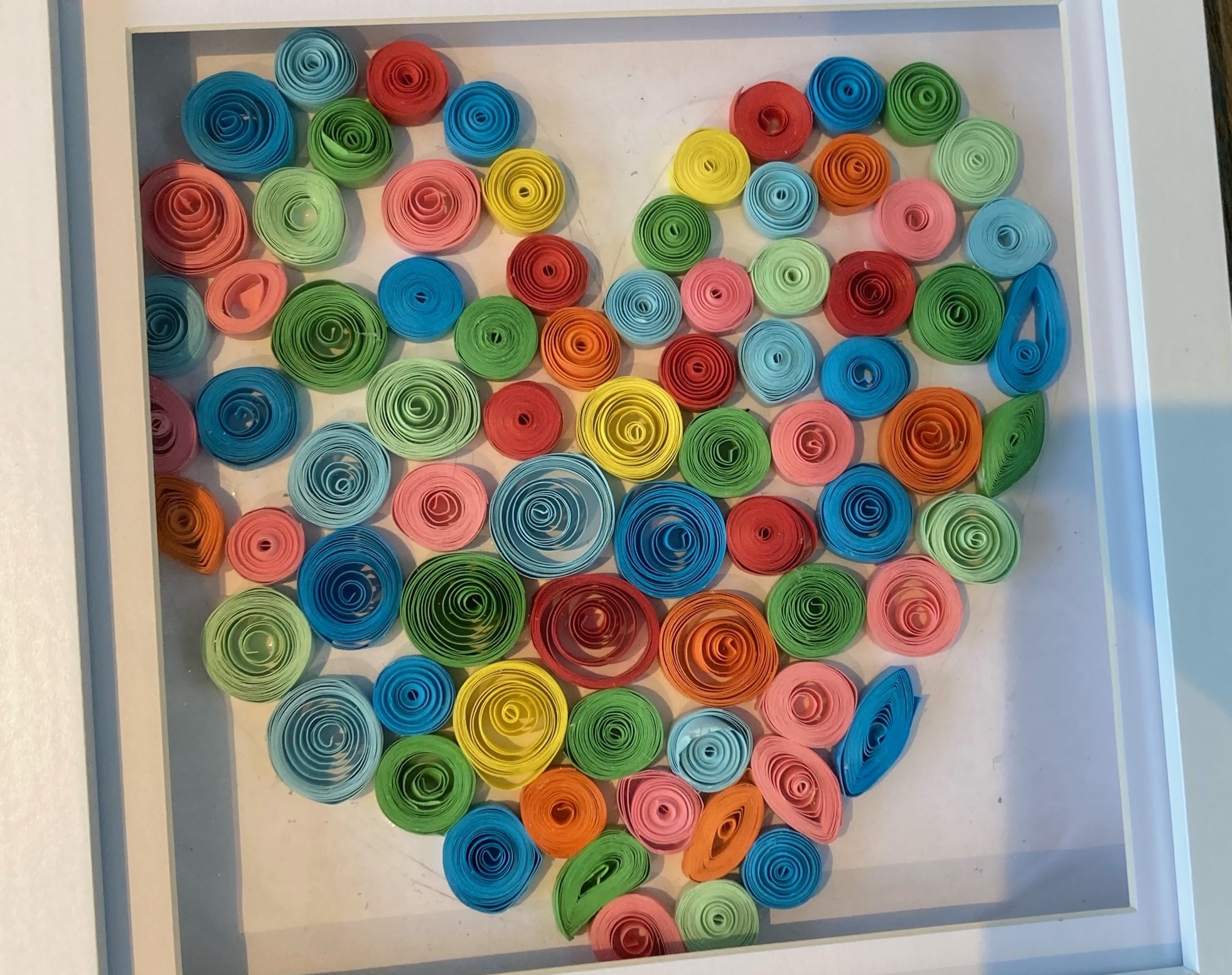 The art of paper quilling shaped into a heart