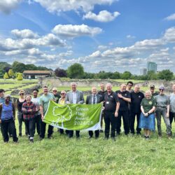 19 people standing in front of Lesnes Abbey with new 2024 Green Flag Award